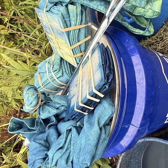 Bound napkins turning from green to blue on the indigo bucket lid